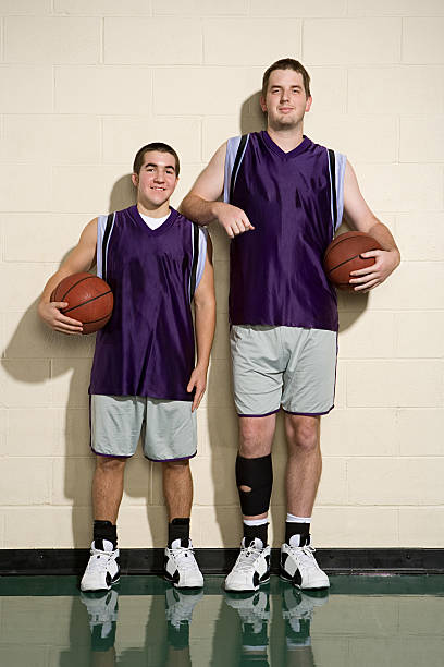 istock Tall and short basketball players 536109517
