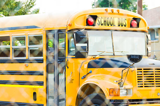 istock School Bus Behind A Chain-link Fence 536111455