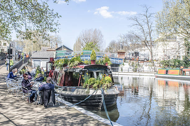 Restaurant peniche in Paddington Basin during day of Sprintime London, England - May 4, 2016: People eating at the terrace of a restaurant peniche in Paddington Basin (Little Venice, London) during day of Sprintime little venice london stock pictures, royalty-free photos & images