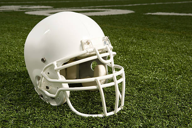 istock Helmet on american football field 536112853