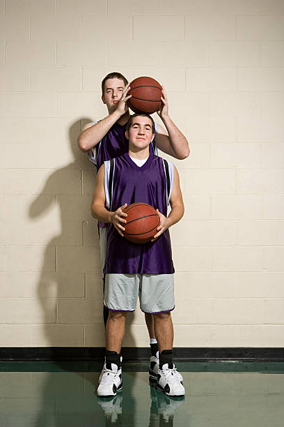 istock Tall and short basketball players 536112855