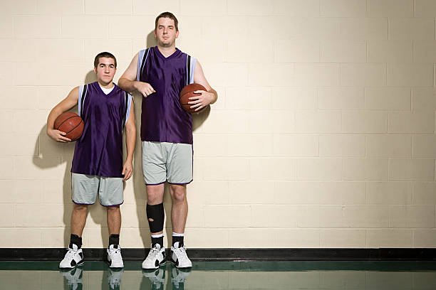 istock Tall and short basketball players 536112875