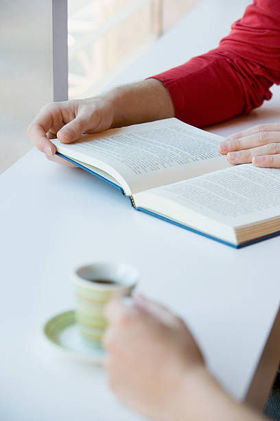 istock Two people with a book and a cup of coffee 536134415