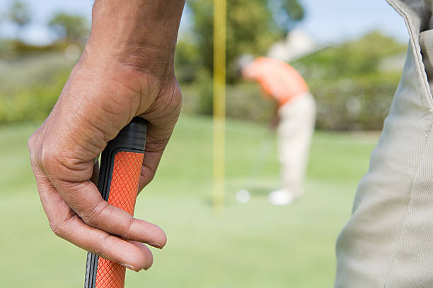 istock Man holding a golf club 536134477