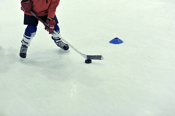 istock hockey player with the puck on training 536135365