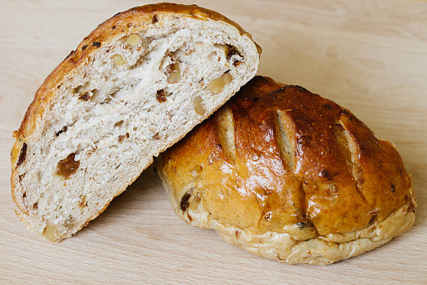 istock Fresh whole grain bread cut in half on cutting board 536136295
