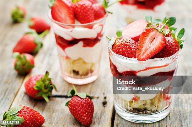 Layered Dessert With Strawberries Biscuit Cake And Cream Cheese Stock Photo - Download Image Now