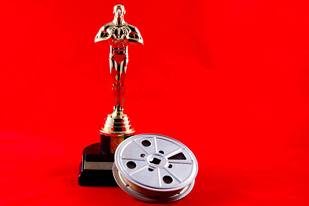 Oscar Statuette with Movie Reel stock photo