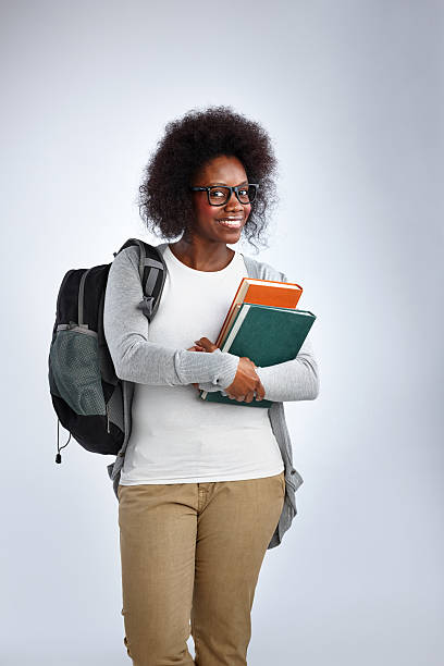 istock Attractive african woman with backpack and books 536139309