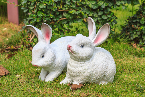 Statue of rabbit on grass in the garden