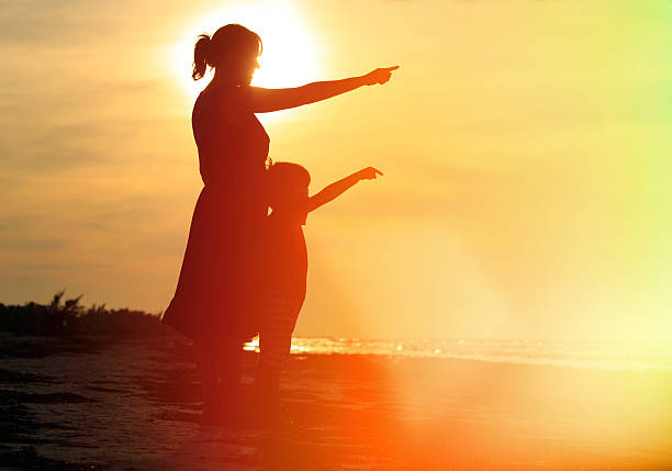 istock mother and son at sunset beach 536141329