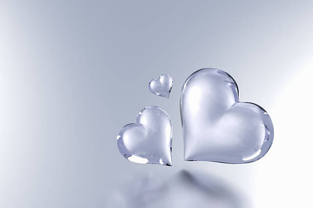 Glass hearts isolated on grey colour background - 3d render
