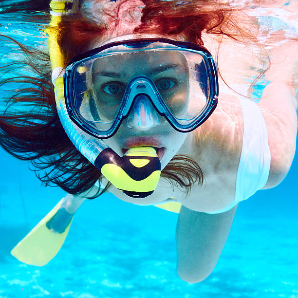 istock Woman with mask snorkeling 536141567