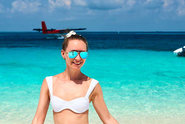 istock Woman at beach. Seaplane at background. 536168841