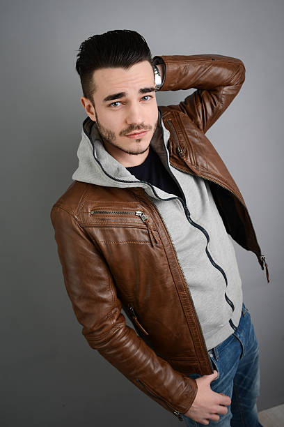 istock handsome young trendy man in brown leather jacket 536169293