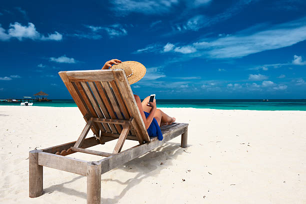 istock Young woman with mobile phone at the beach 536170203