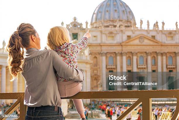 Mother And Baby Girl Pointing On Basilica Di San Pietro Stock Photo - Download Image Now