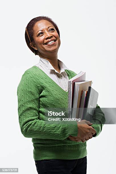 Portrait Of Teacher Holding Books Stock Photo - Download Image Now - Teacher, White Background, Cut Out