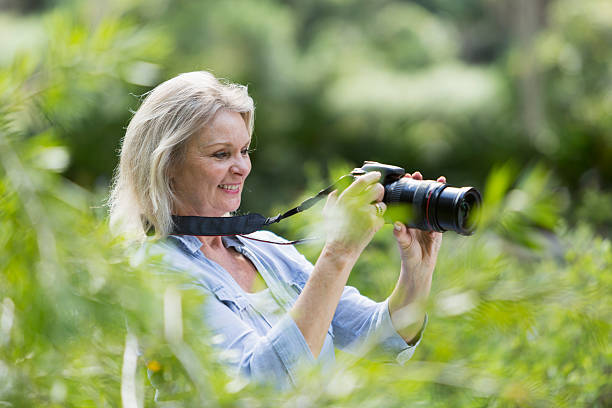 istock Senior woman taking photographs with camera 536189959