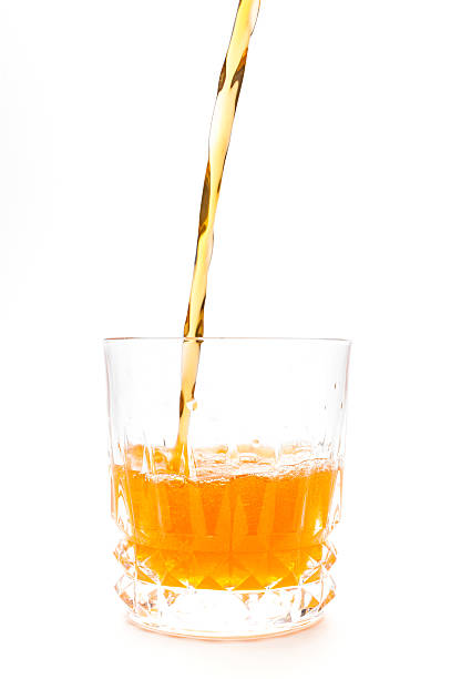istock Orange juice into the glass isolated 536191179