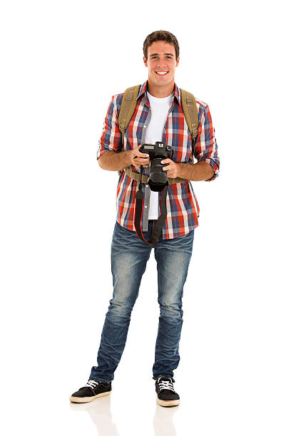 handsome male tourist with a camera on white background