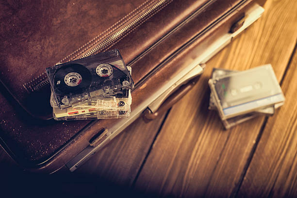 Cassette tape lying on an old suitcase. Vintage Retouching stock photo