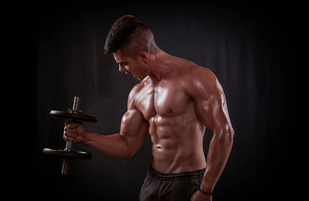 istock Strong Man Exercising With Dumbbells In A Gym 536194559
