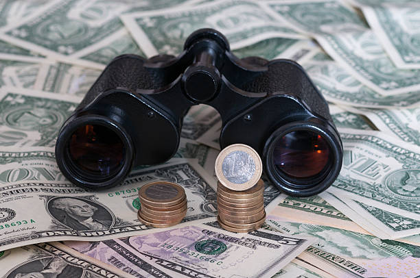 istock Euro and US Dollar with binoculars 536195279