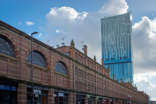 Manchester, United Kingdom - October 4, 2014: Beetham Tower building in Manchester, England with contrasting Victorian buidlings in the foreground. This image is backlit against a bright cloudy sky.