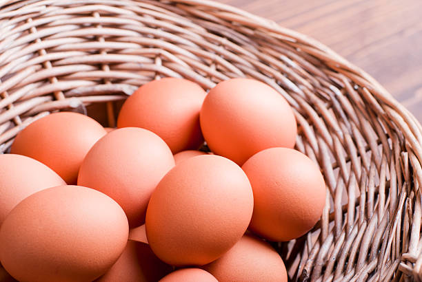 istock brown eggs in a wicker basket  brown table top view 536196393