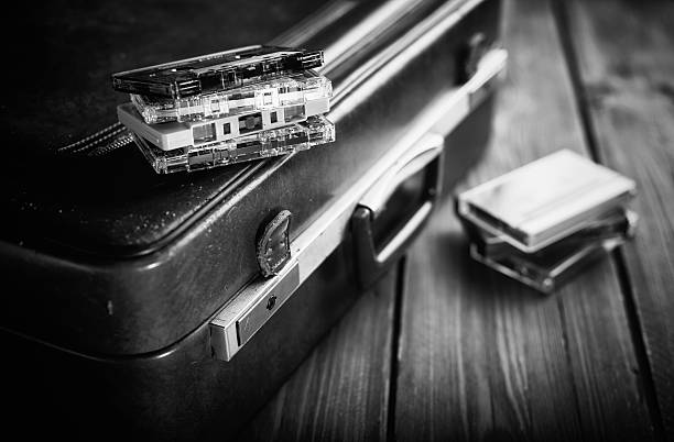 Cassette tape lying on an old suitcase. Vintage Retouching stock photo