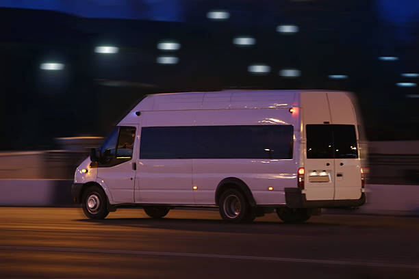 istock minibus moves down the street at night 536215647