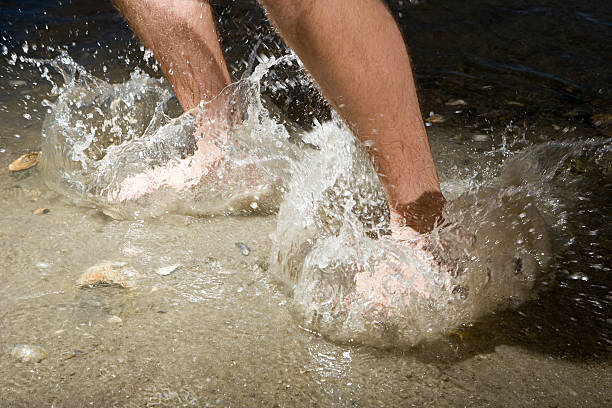 istock Man splashing in the sea 536217087