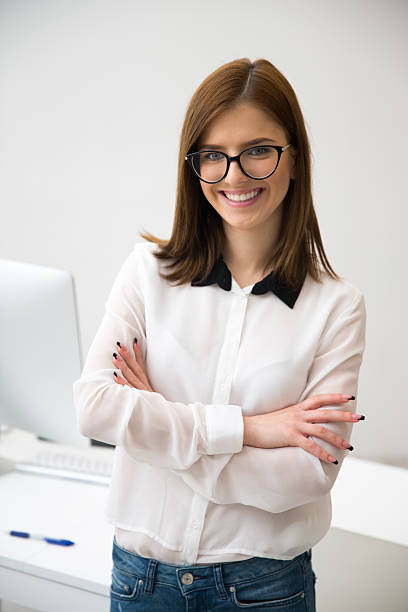 istock happy businesswoman standing with arms folded 536217543