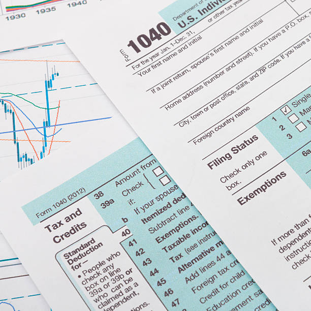 istock US 1040 Tax Form and silver ball pen 536220141