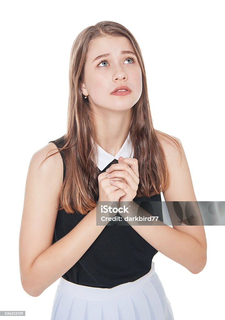 Young teenager girl praying isolated Young teenager girl praying isolated on white background 2015 Stock Photo