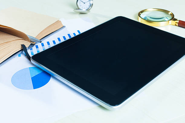 istock table with tablet,chart,and office supplies. 536222233