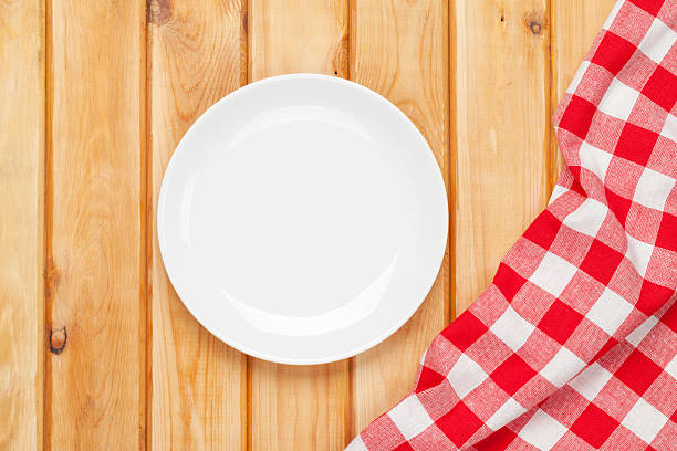 istock Empty plate and towel over wooden table background 536222457