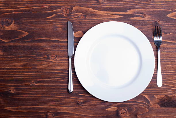 istock white plate and fork next  knife  wooden board top view 536243871