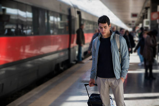 istock Handsome young male traveler in train station 536244699