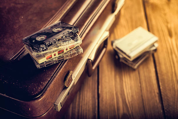 Cassette tape lying on an old suitcase. Vintage Retouching stock photo