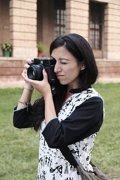 Young female photographer shooting with her camera.
