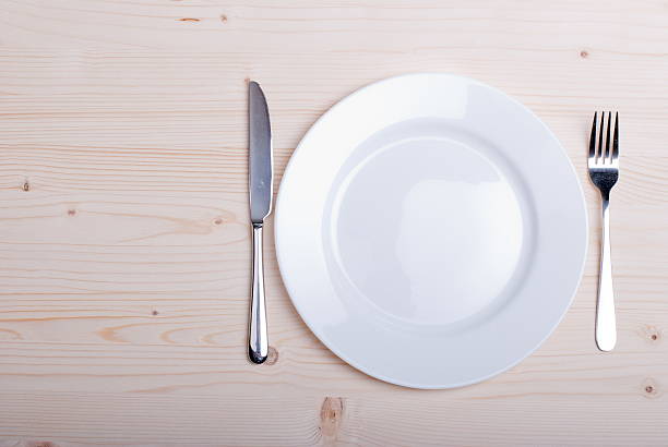 istock white plate and fork next  knife  wooden board top view 536247761