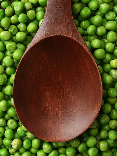 istock Empty wooden spoon over green peas 536249011