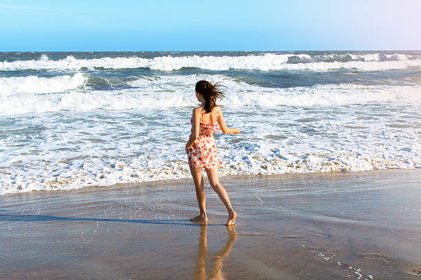 istock Young woman dancing on the beach 536249247