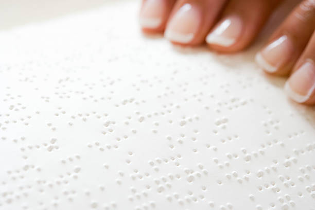 istock Woman reading braille 536249943