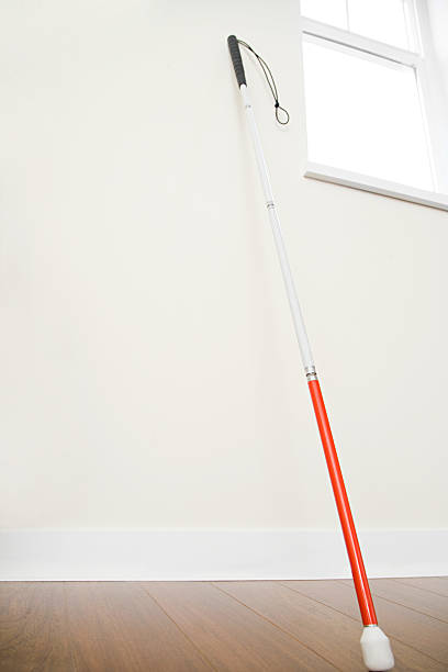 Walking stick against a wall Walking stick against a wall blind persons cane stock pictures, royalty-free photos & images