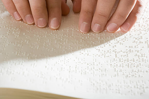 istock One woman reading braille 536250007