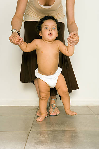 istock Mother helping baby to walk 536251105