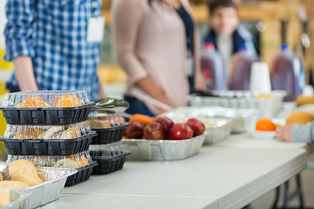 Donated food prepared to be served in soup kitchen Donated food prepared to be served in soup kitchen soup kitchen stock pictures, royalty-free photos & images